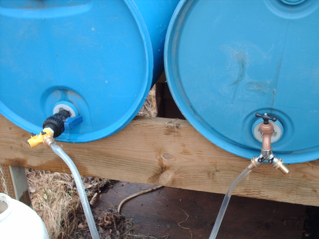 two rain barrels with hose connection