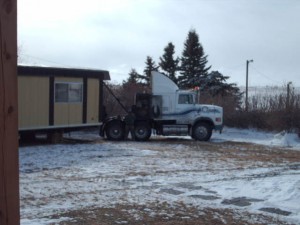 Mobile home being moved in winter