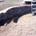 patio retaining wall before paving stones and cap stones on wall